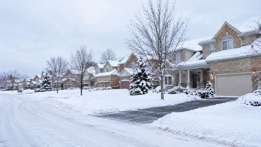 Residential street of homes with cleared driveways during winter